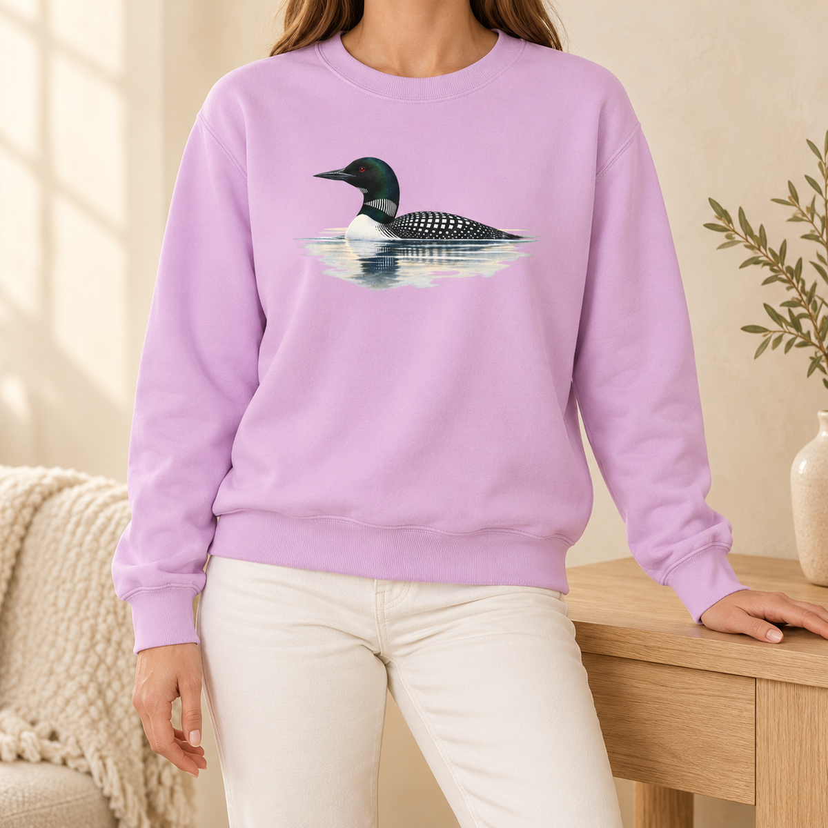 Common Loon Sweatshirt in Orchid - a watercolor loon in breeding plumage on misty water, printed on a garment-dyed Comfort Colors 1566 crewneck, worn by a woman