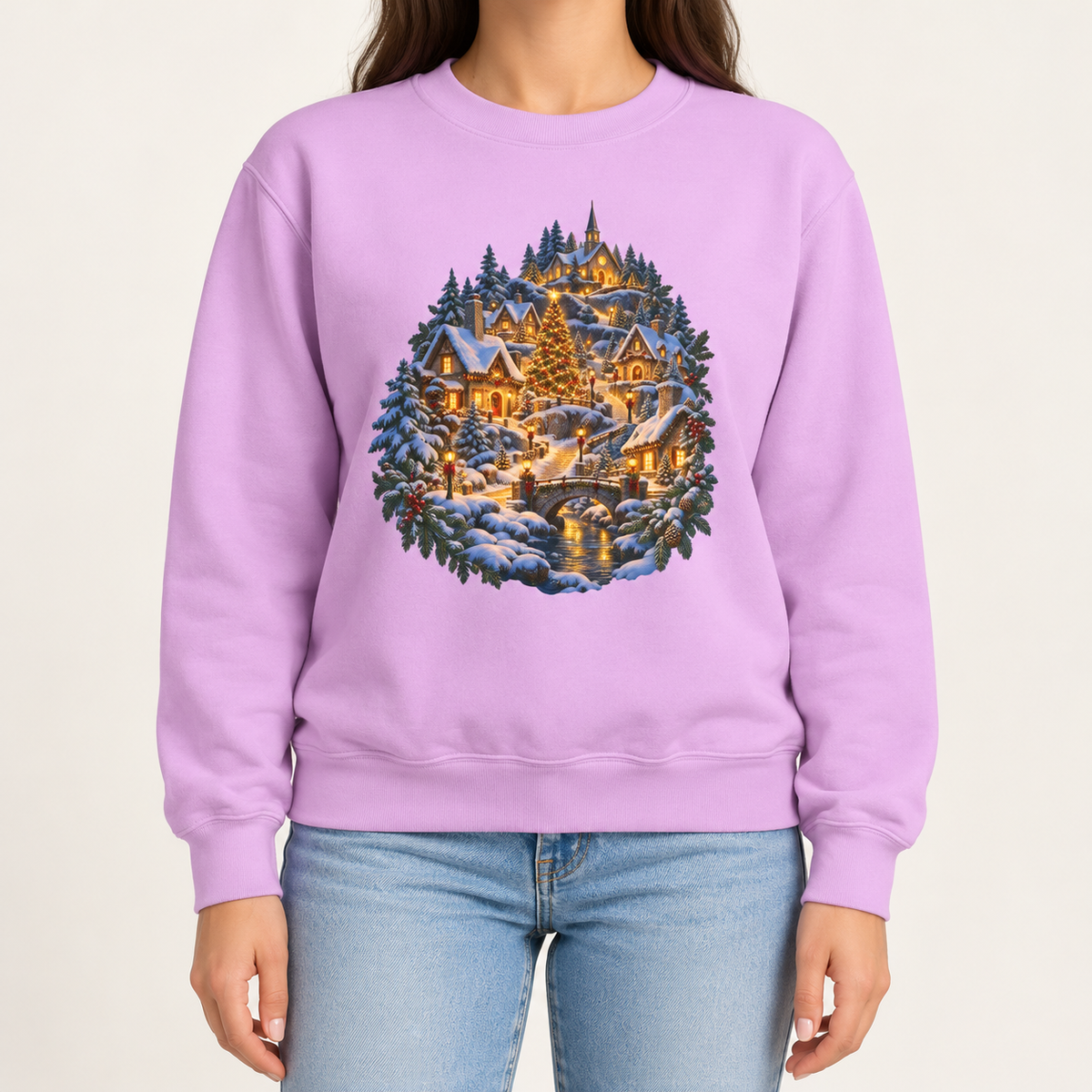 Small town Christmas sweatshirt in Orchid: a snowy hillside village with a lit church, Christmas tree and stone bridge, on a light lavender garment-dyed Comfort Colors crewneck