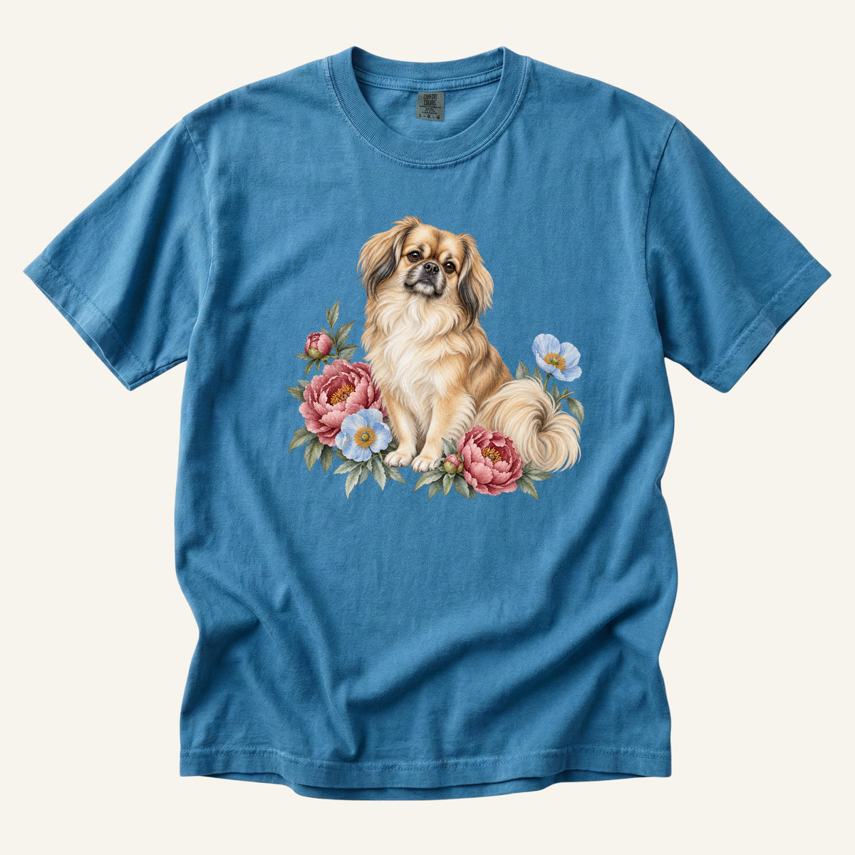 Pekingese T-Shirt in Sapphire — a golden Pekingese among rose-pink peonies and blue poppies on garment-dyed cotton