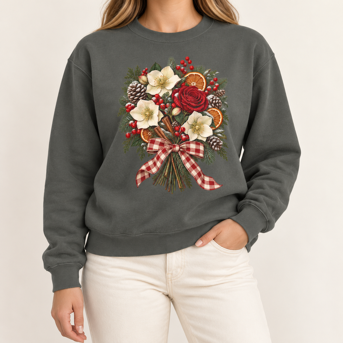 Winter bouquet sweatshirt in Pepper – cream hellebores, a red rose, dried orange slices, cinnamon and pinecones tied with a red gingham bow, printed large on the chest of a Comfort Colors crewneck