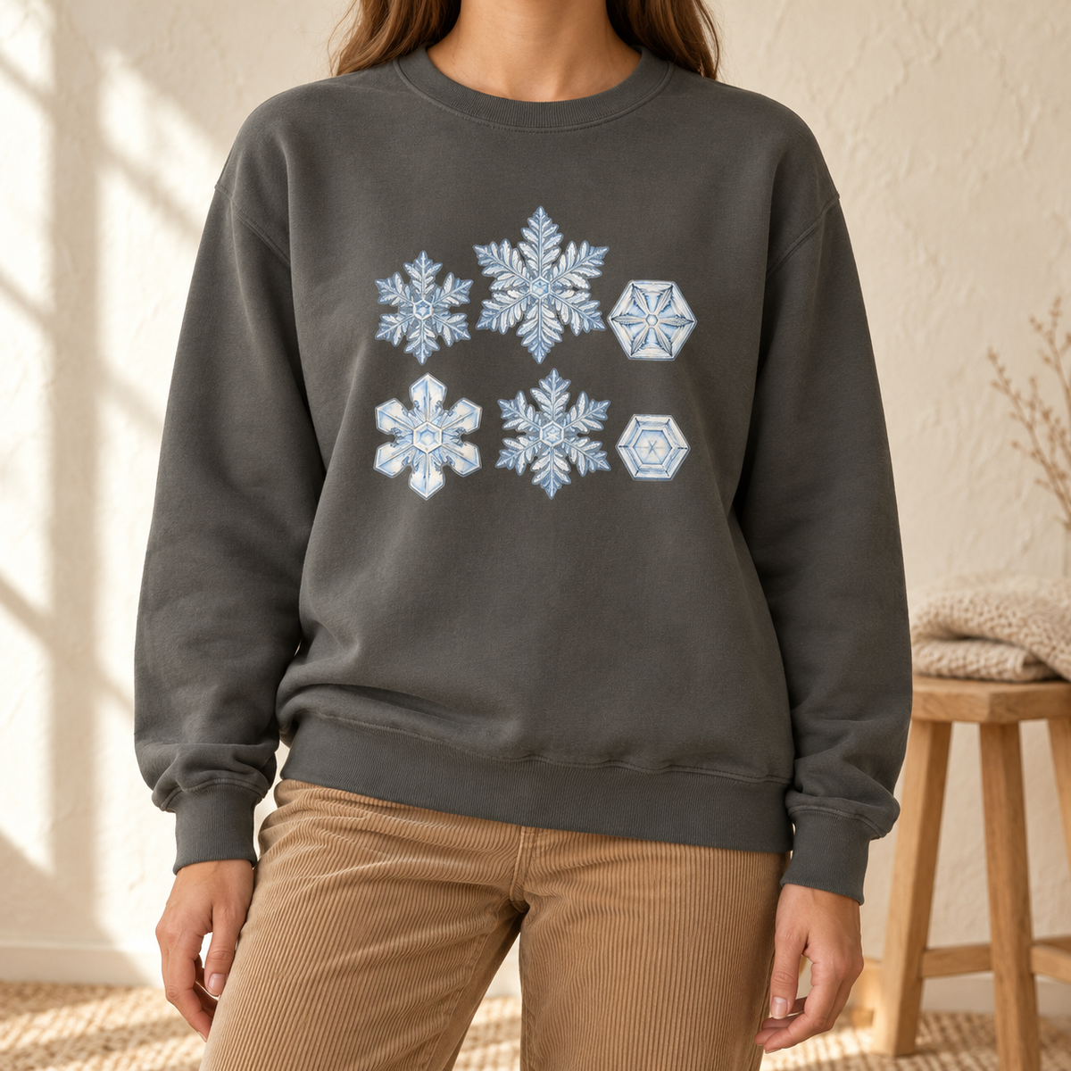 Snowflake Study Sweatshirt in Pepper - six watercolor snow crystals on a charcoal Comfort Colors crewneck, worn by a woman