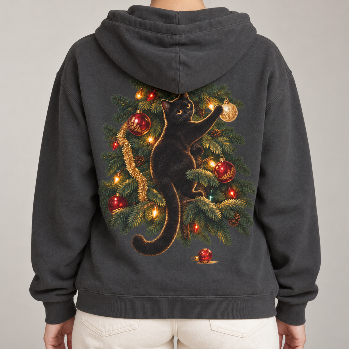 Black Cat Christmas hoodie in Pepper worn, back view with a black cat climbing a lit Christmas tree