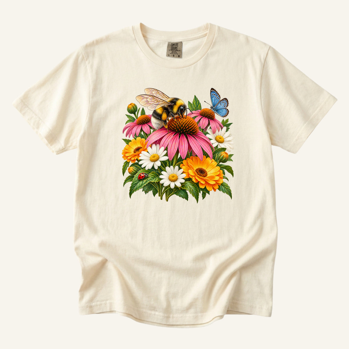 Pollinator Garden T-Shirt in Ivory - bumblebee, pink coneflower, white daisies, orange blooms, blue butterfly and ladybug, front-centered print on garment-dyed cotton