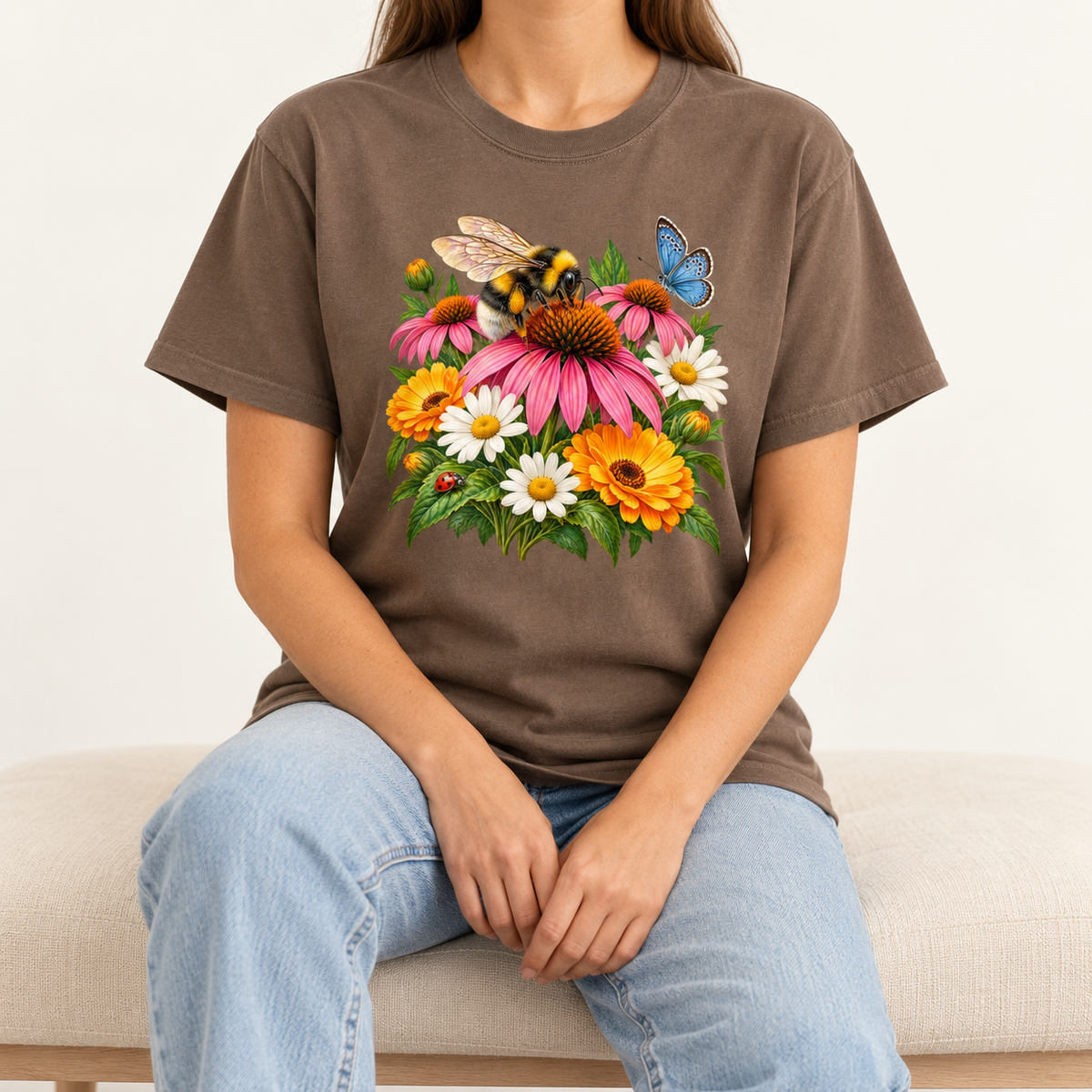 The Espresso Pollinator Garden tee worn, showing the bumblebee and coneflower print centered on the chest