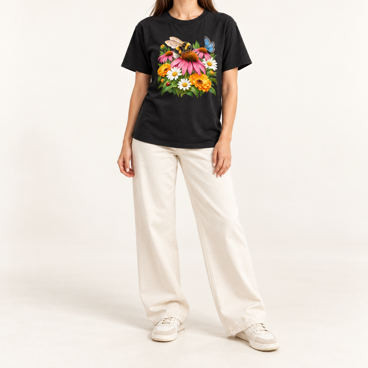 The Pollinator Garden tee worn, showing the bumblebee, coneflower, daisies, butterfly and ladybug print centered on the chest