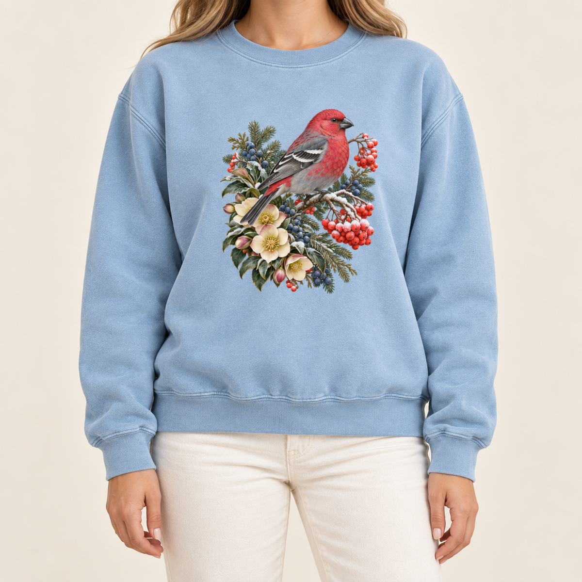 Vintage botanical bird illustration printed on a 9.5 oz garment-dyed cotton-blend crewneck — a bright red bird among evergreen sprigs, red and blue berries and cream flowers