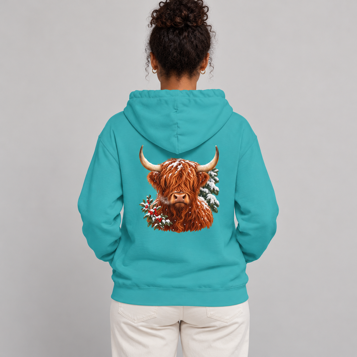 Winter Highland Cow hoodie in Seafoam worn, highland cow with holly and snowy pine