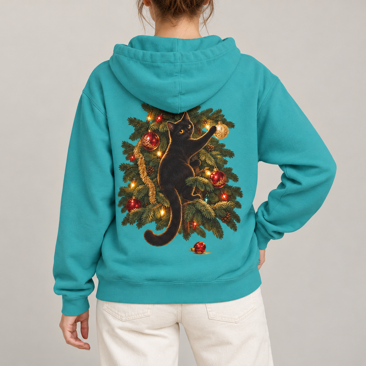 Black Cat Christmas hoodie in Seafoam worn, back view with the cat climbing the Christmas tree