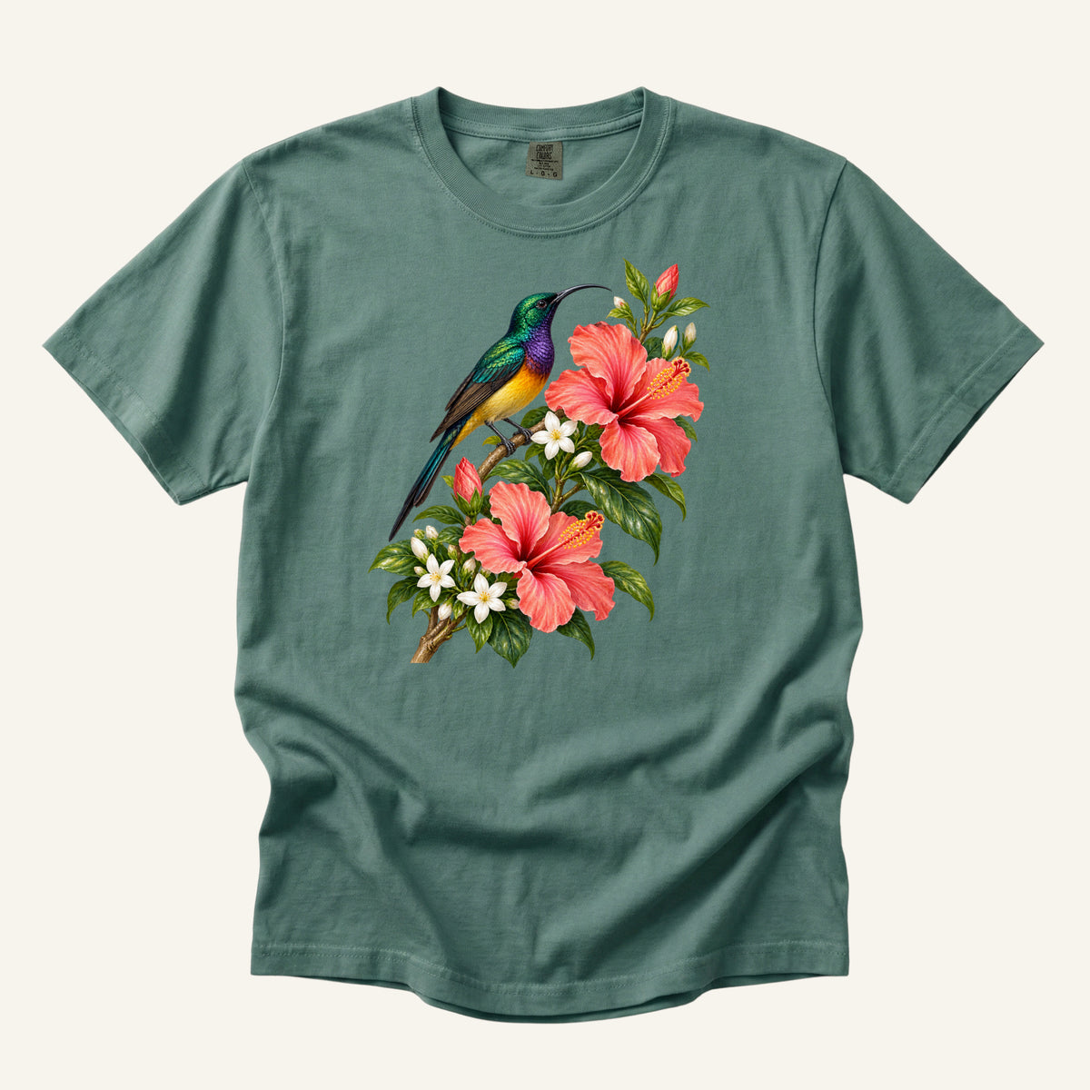 Jewel-colored tropical bird beside coral hibiscus flowers and glossy green leaves, printed on a Light Green Comfort Colors 1717 unisex t-shirt