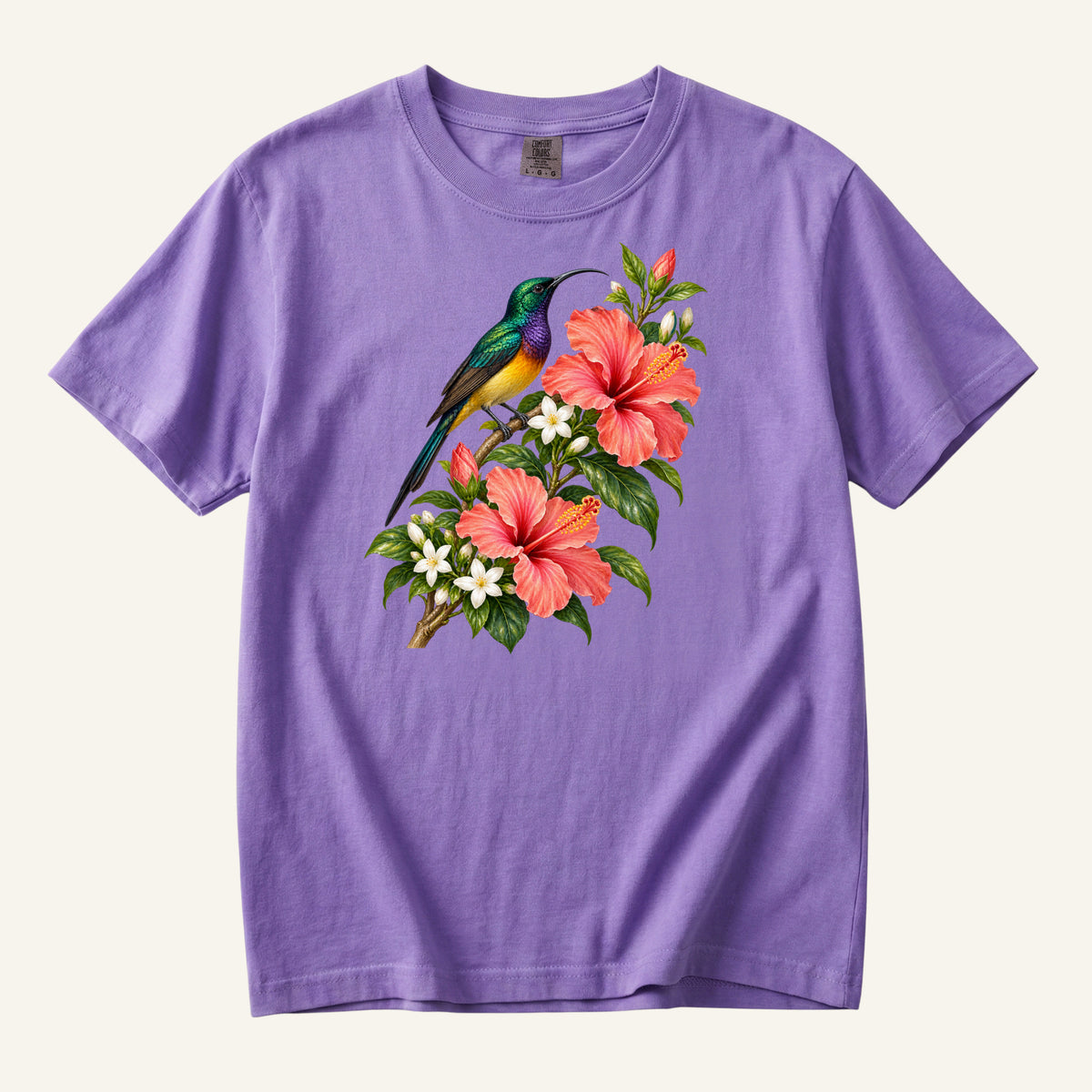 Jewel-colored tropical bird beside coral hibiscus flowers and glossy green leaves, printed on a Violet Comfort Colors 1717 unisex t-shirt