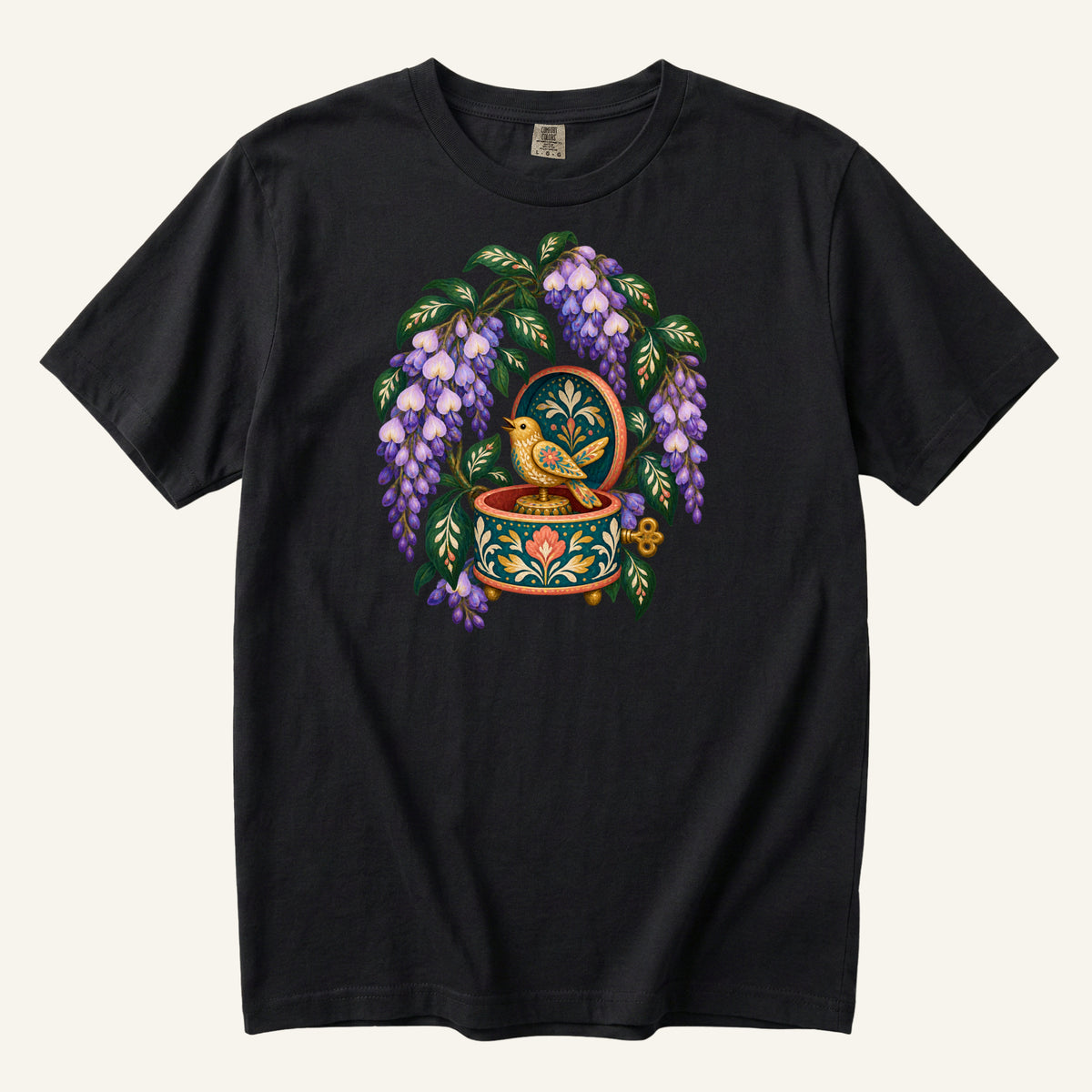 Folk-art music box with purple wisteria and a golden bird illustration on a Black Comfort Colors t-shirt