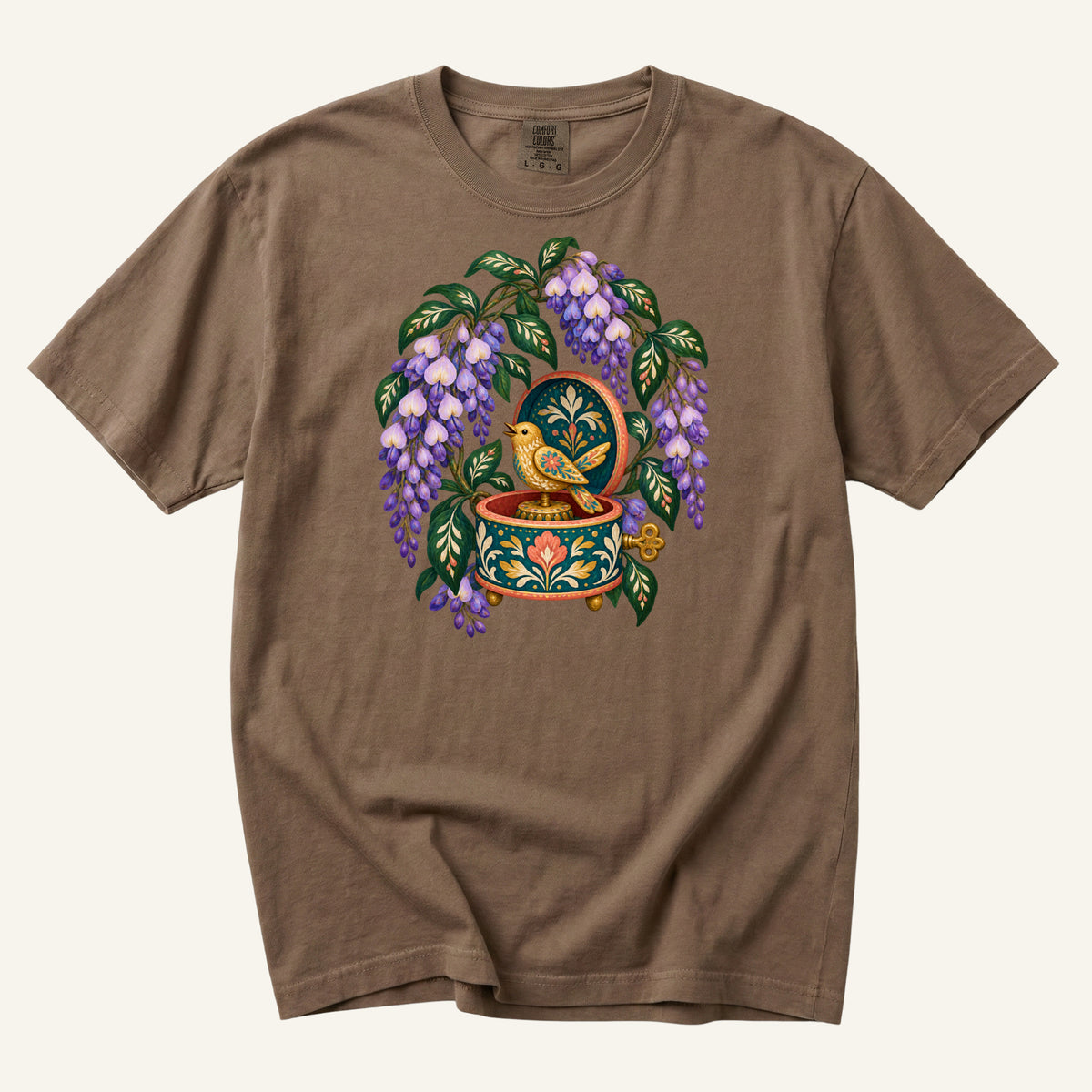 Folk-art music box with purple wisteria and a golden bird illustration on an Espresso brown Comfort Colors t-shirt