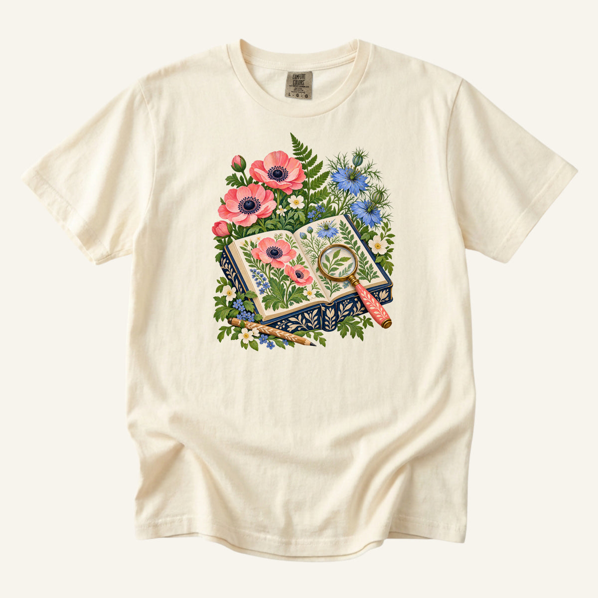 Botanical book, magnifying glass and wildflowers illustration on an Ivory Comfort Colors t-shirt