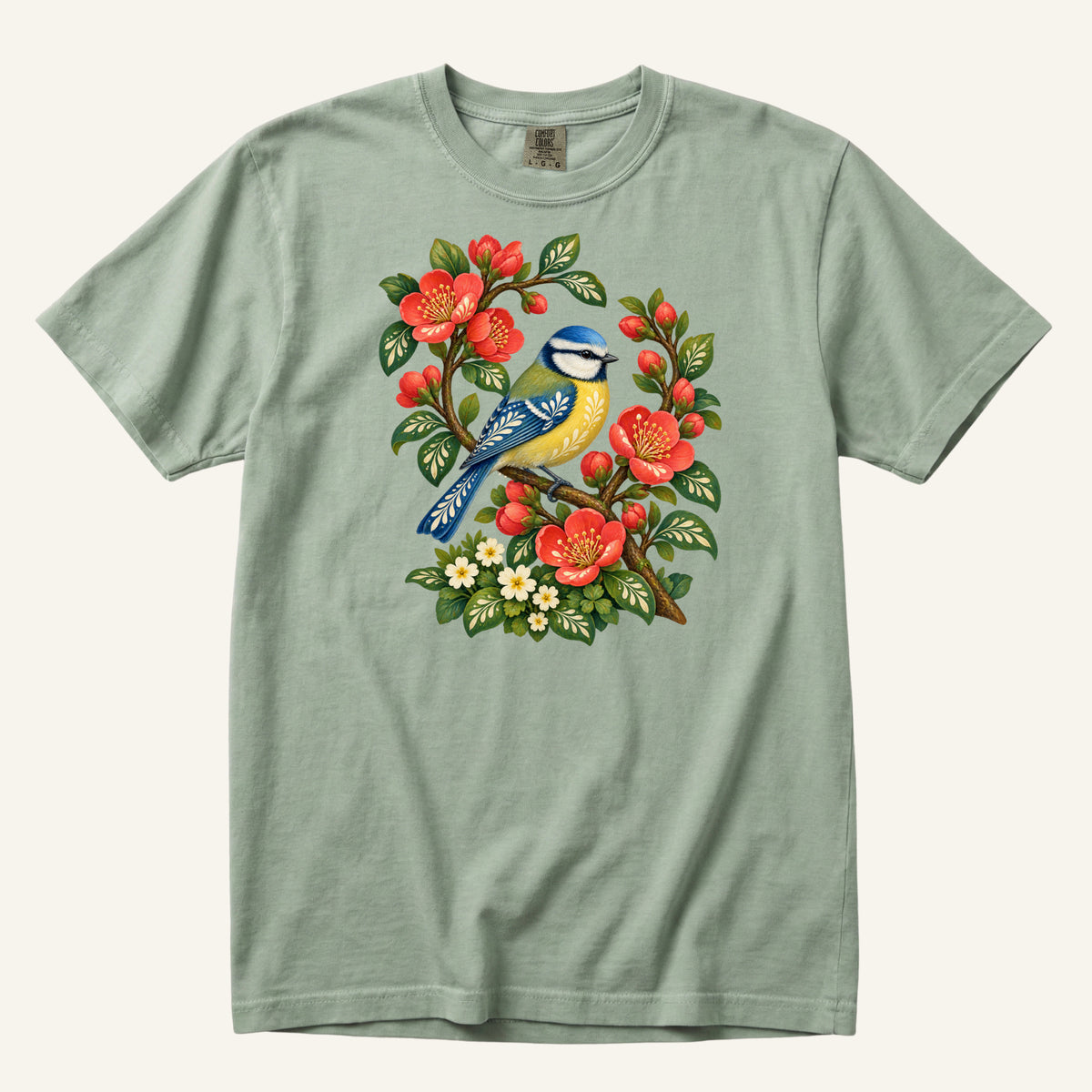 Folk Art Songbird & Red Blossom T-Shirt in Bay — a gentle green backdrop that lets the red flowers stand out
