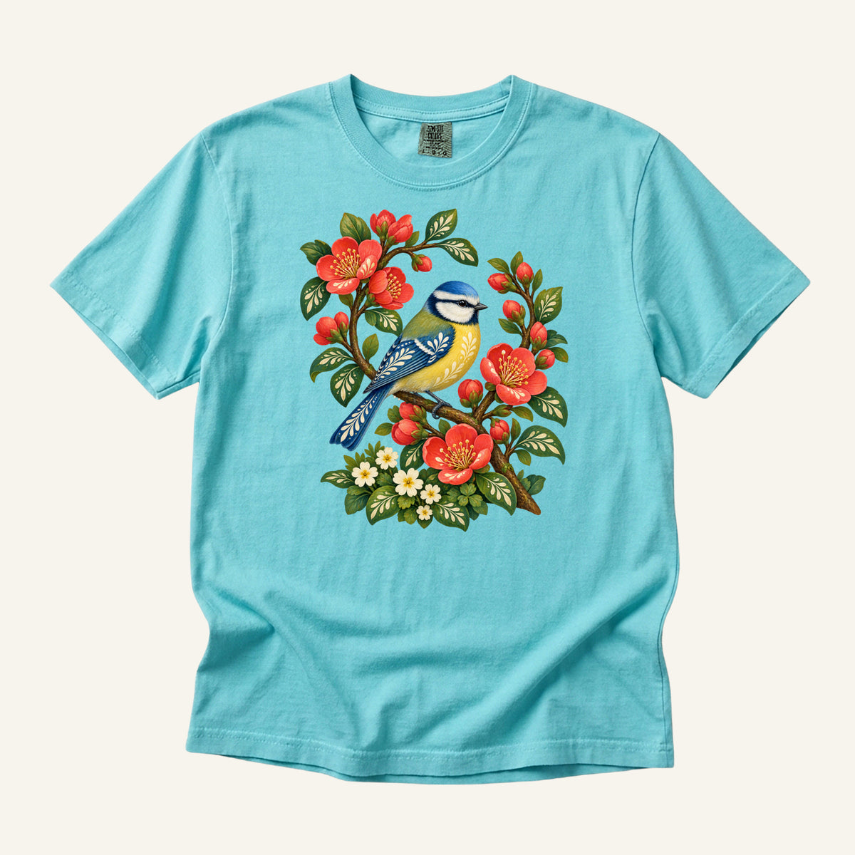 Folk Art Songbird & Red Blossom T-Shirt in Lagoon Blue — a bright, lively pairing with strong contrast against the red blossoms
