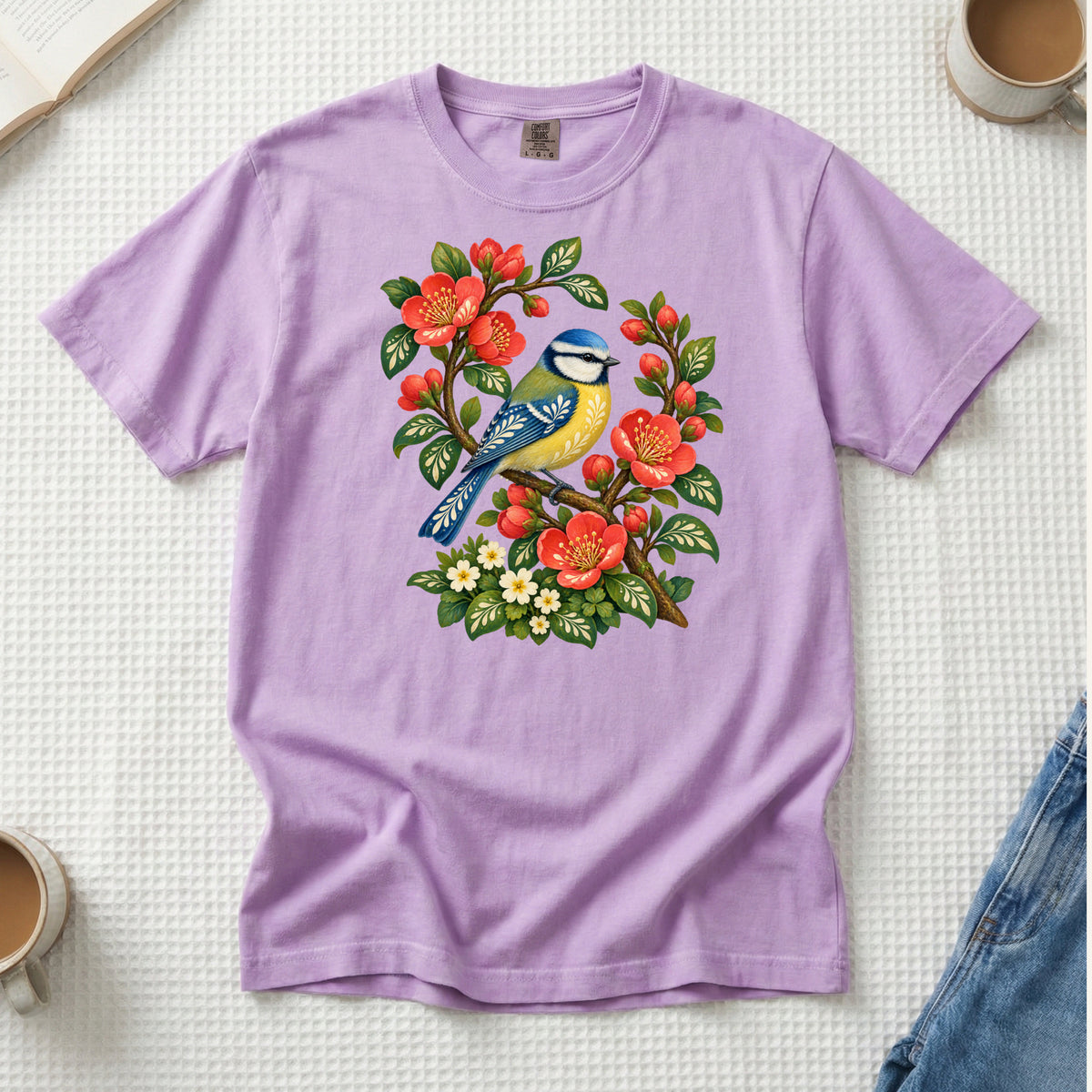 Folk Art Songbird & Red Blossom T-Shirt in Orchid — a playful pastel that complements the blue plumage