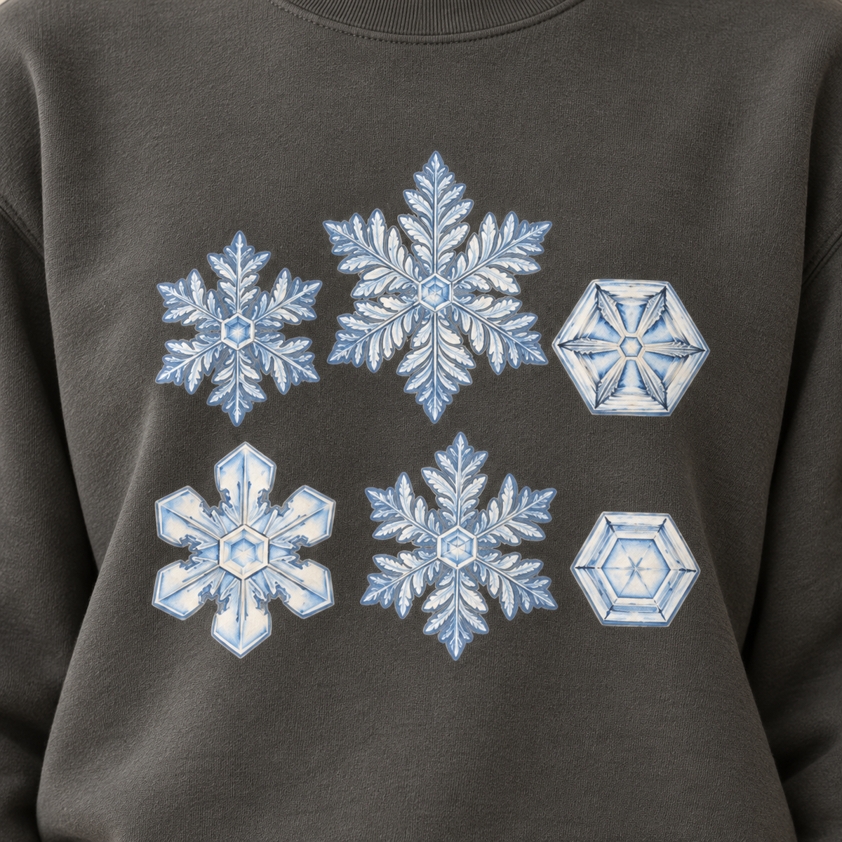 Close-up of the snowflake study print on a Pepper garment-dyed Comfort Colors sweatshirt - white snow crystals on charcoal