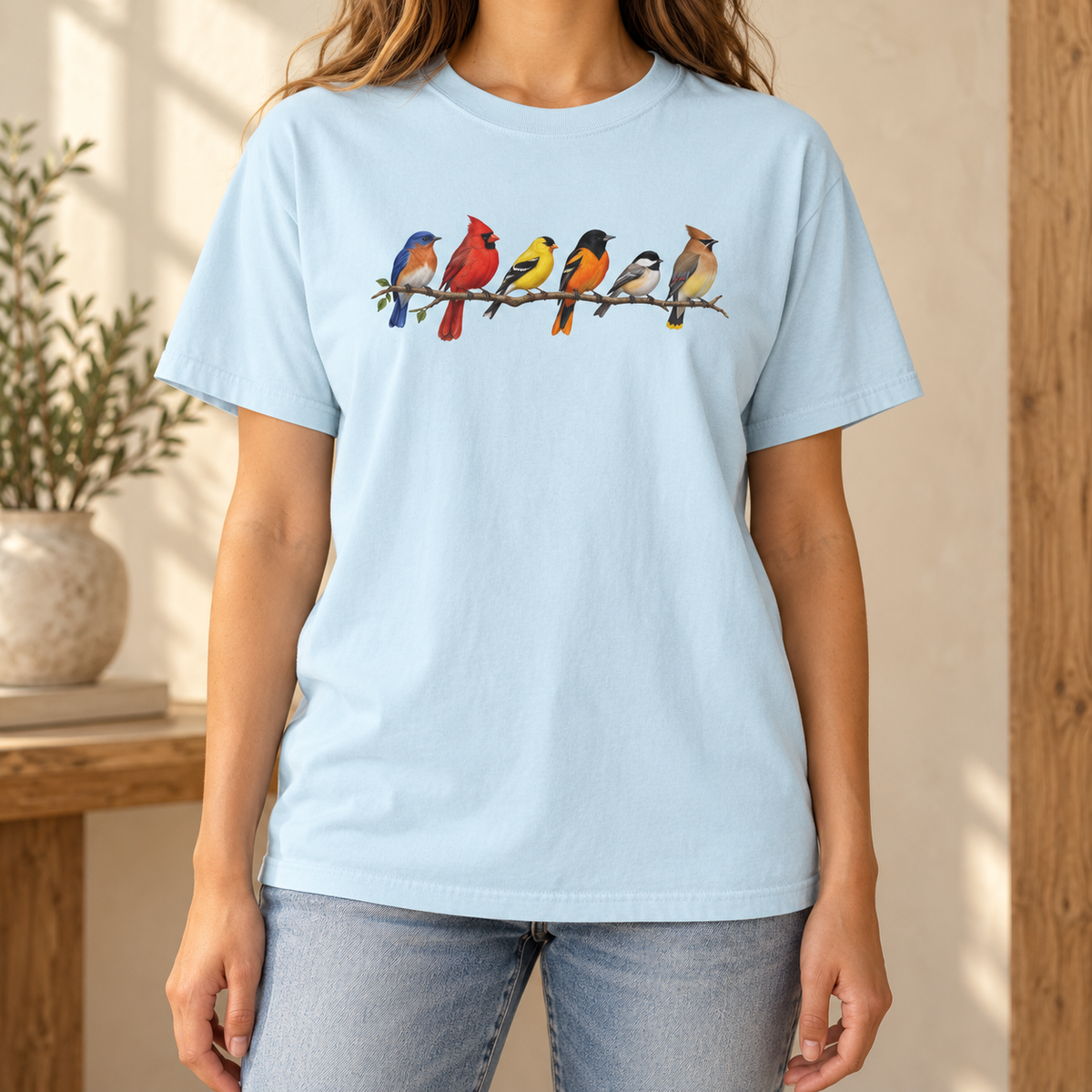 Colorful Birds on Branches t-shirt in Chambray — six painted songbirds on one branch: chickadee, goldfinch, cedar waxwing, northern cardinal, Baltimore oriole and eastern bluebird, on a garment-dyed Comfort Colors tee