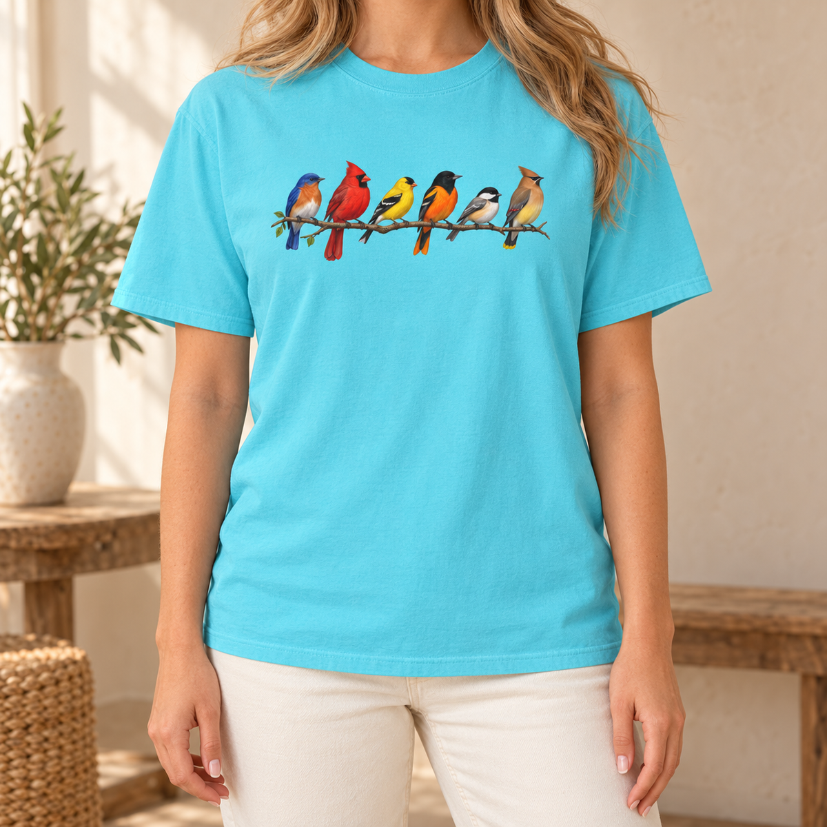 Colorful Birds on Branches t-shirt in Lagoon Blue — six painted songbirds on one branch: chickadee, goldfinch, cedar waxwing, northern cardinal, Baltimore oriole and eastern bluebird, on a garment-dyed Comfort Colors tee