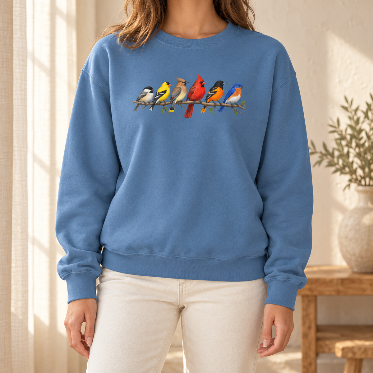 Colorful Birds on Branches sweatshirt in Blue Jean — six painted songbirds on one branch: chickadee, goldfinch, cedar waxwing, northern cardinal, Baltimore oriole and eastern bluebird, on a garment-dyed Comfort Colors crewneck