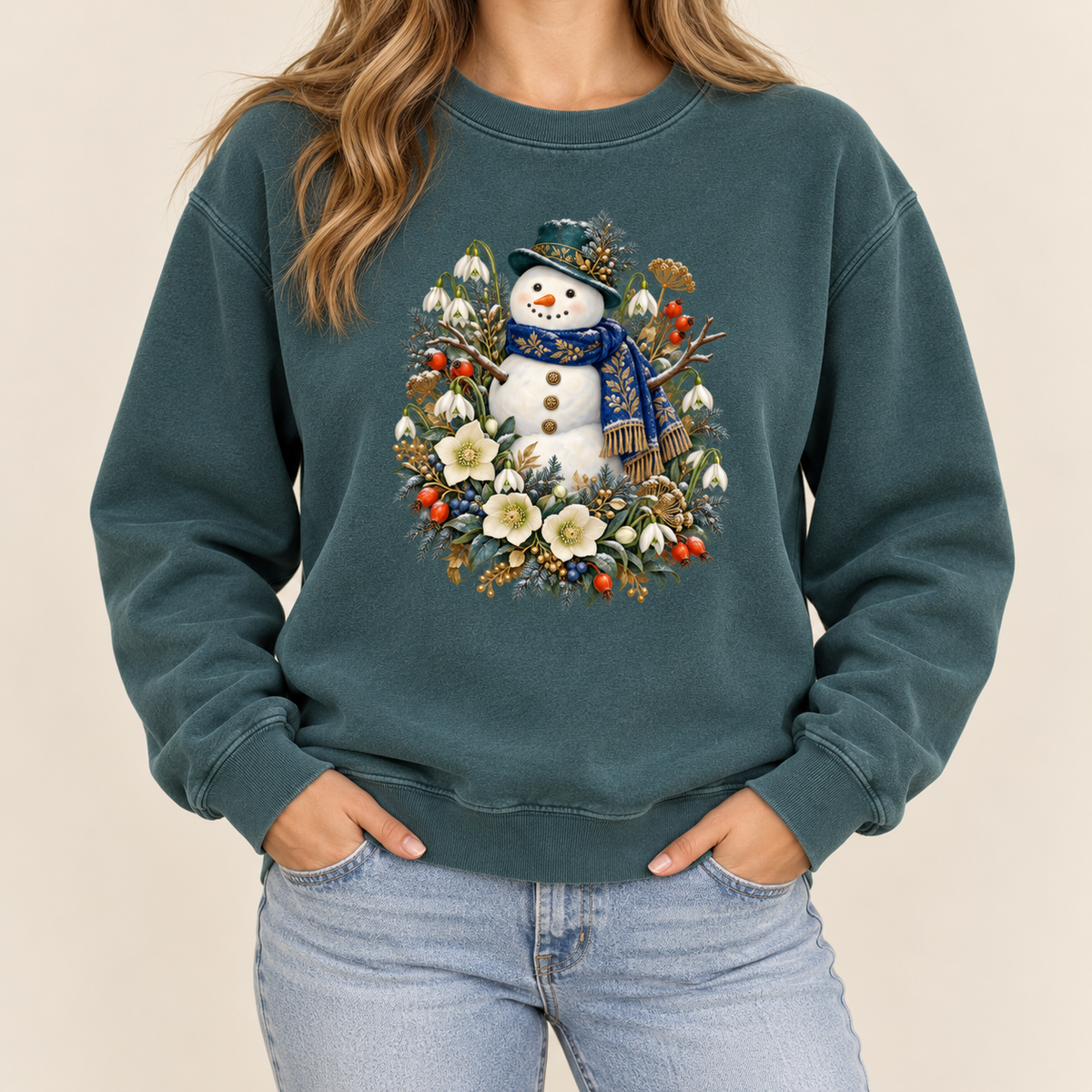 Snowman and winter botanicals print on a 9.5 oz garment-dyed cotton-blend crewneck — a smiling snowman in a dark hat and blue scarf among evergreen, red berries and cream flowers