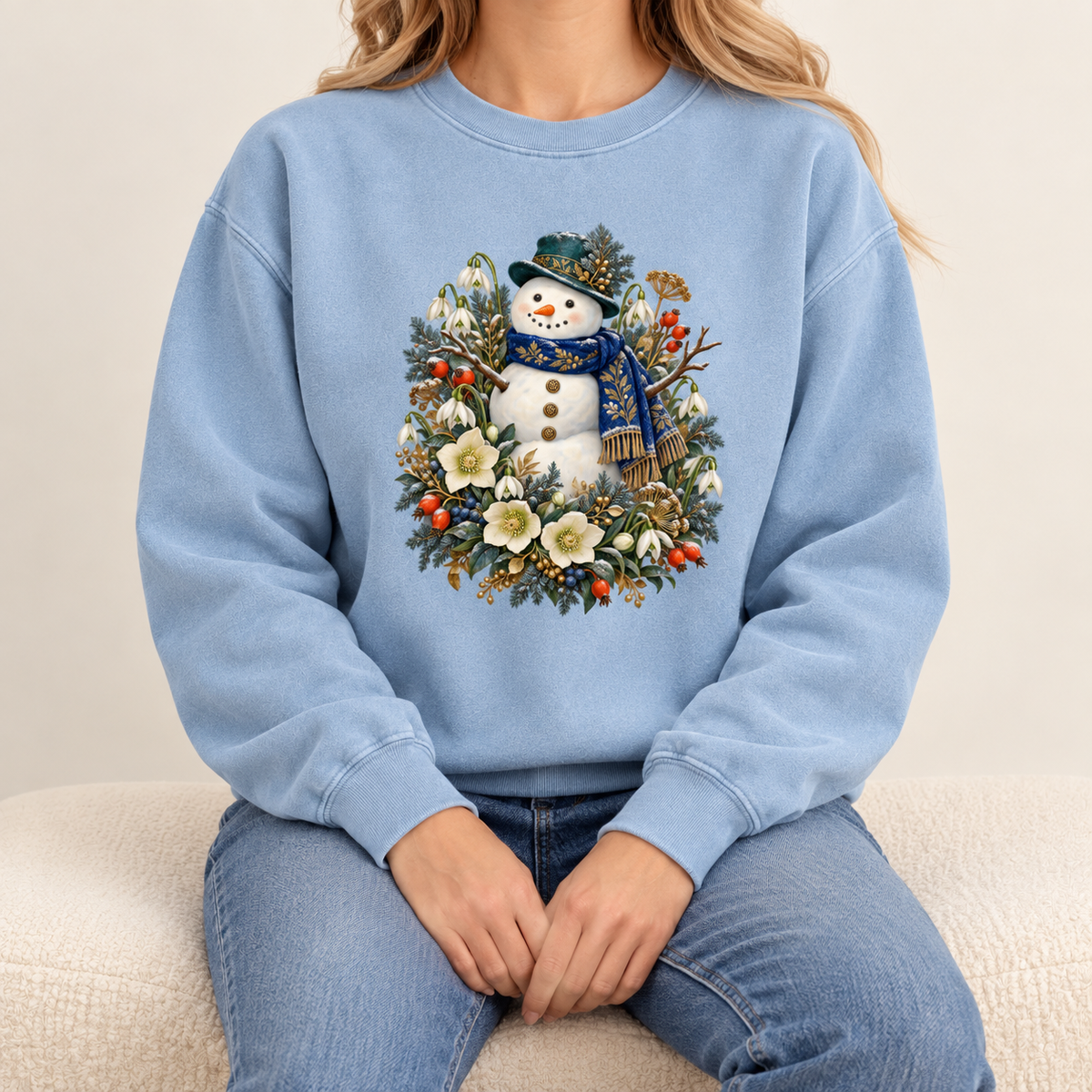Snowman design printed direct-to-garment on garment-dyed fleece — a smiling snowman in a dark hat and blue scarf among evergreen, red berries and cream flowers