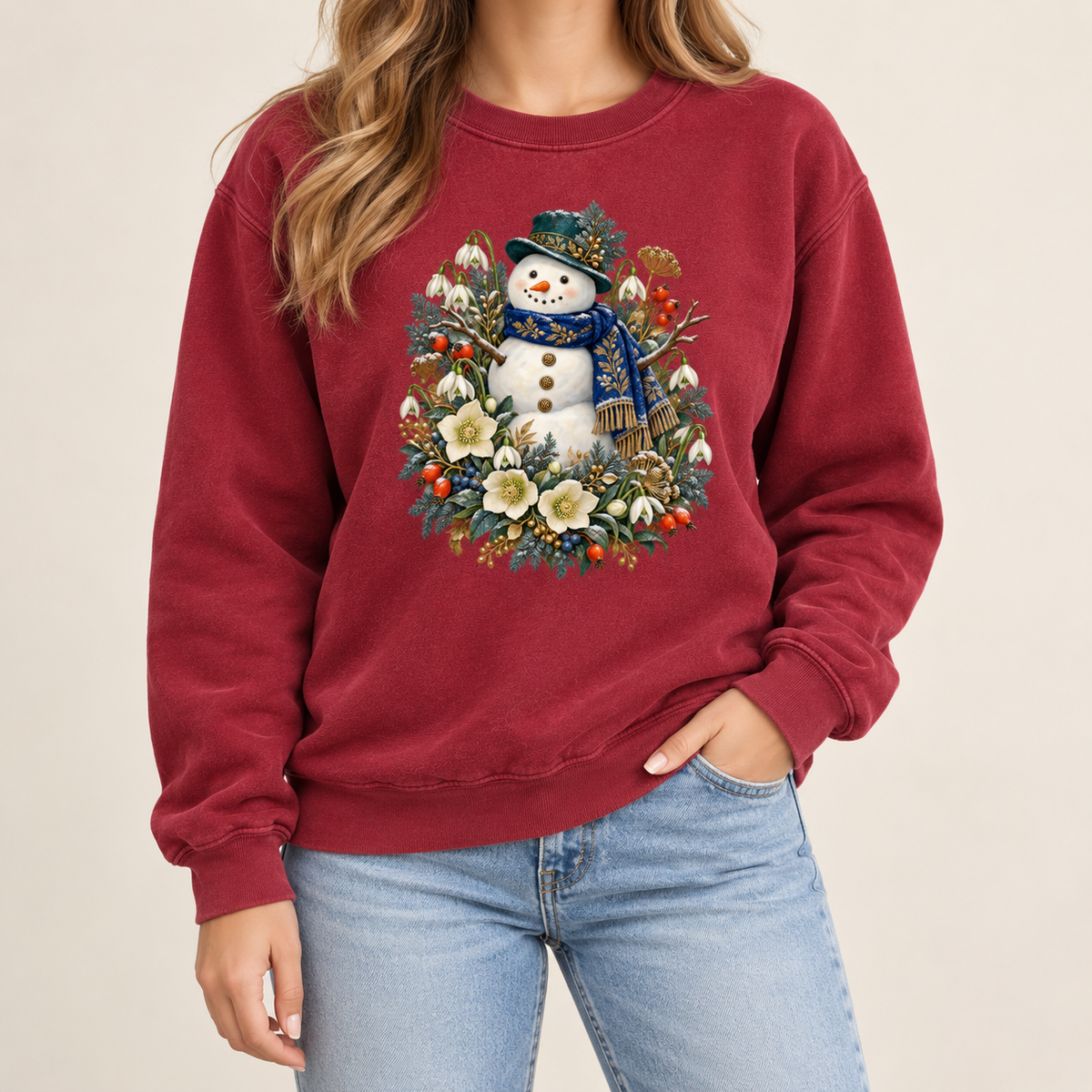 Winter snowman crewneck with 1x1 ribbed collar, cuffs and waistband — a smiling snowman in a dark hat and blue scarf among evergreen, red berries and cream flowers