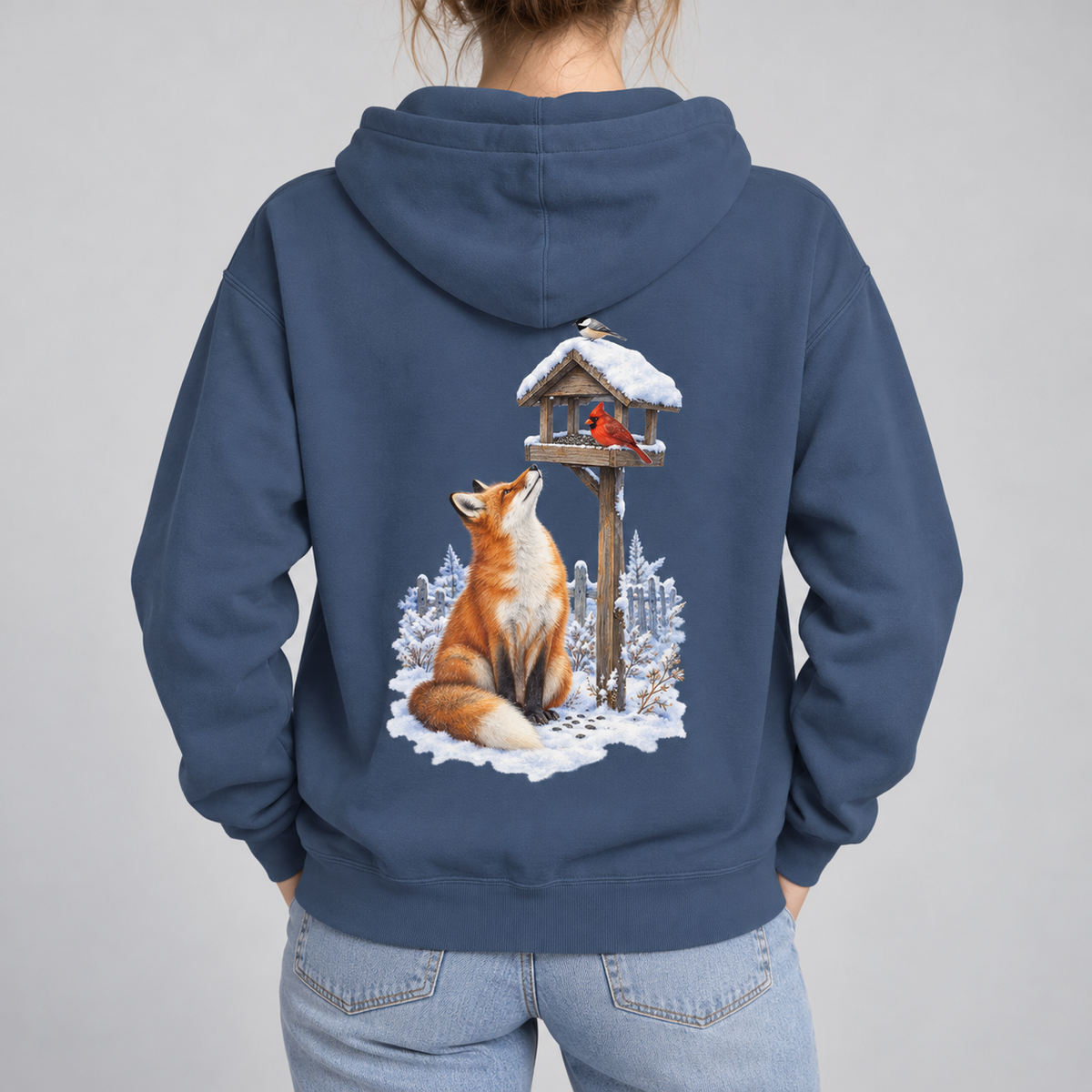 Beneath the Feeder hoodie worn, red fox in snow beneath a cardinal feeder print