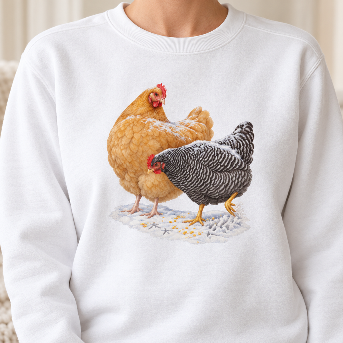 Winter hens sweatshirt in White, flat view – watercolor Buff Orpington and Barred Rock in the snow on a garment-dyed Comfort Colors crewneck
