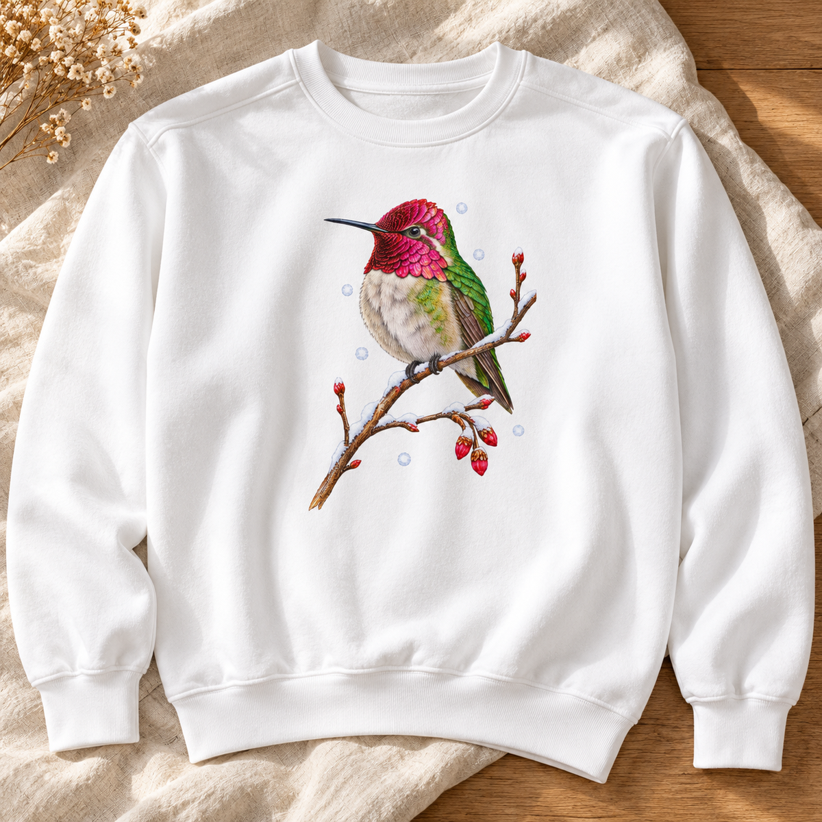 Close-up of the winter hummingbird print on a garment-dyed Comfort Colors crewneck - magenta crown and throat, emerald back, snowy twig and seed heads