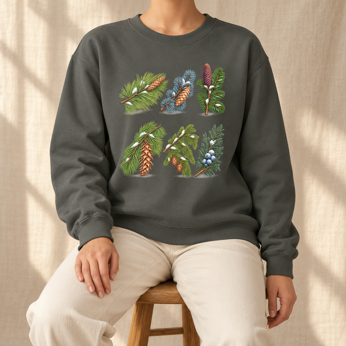 Evergreen Study Sweatshirt in Pepper on linen - six watercolor conifer sprigs with cones and snow on a garment-dyed Comfort Colors crewneck