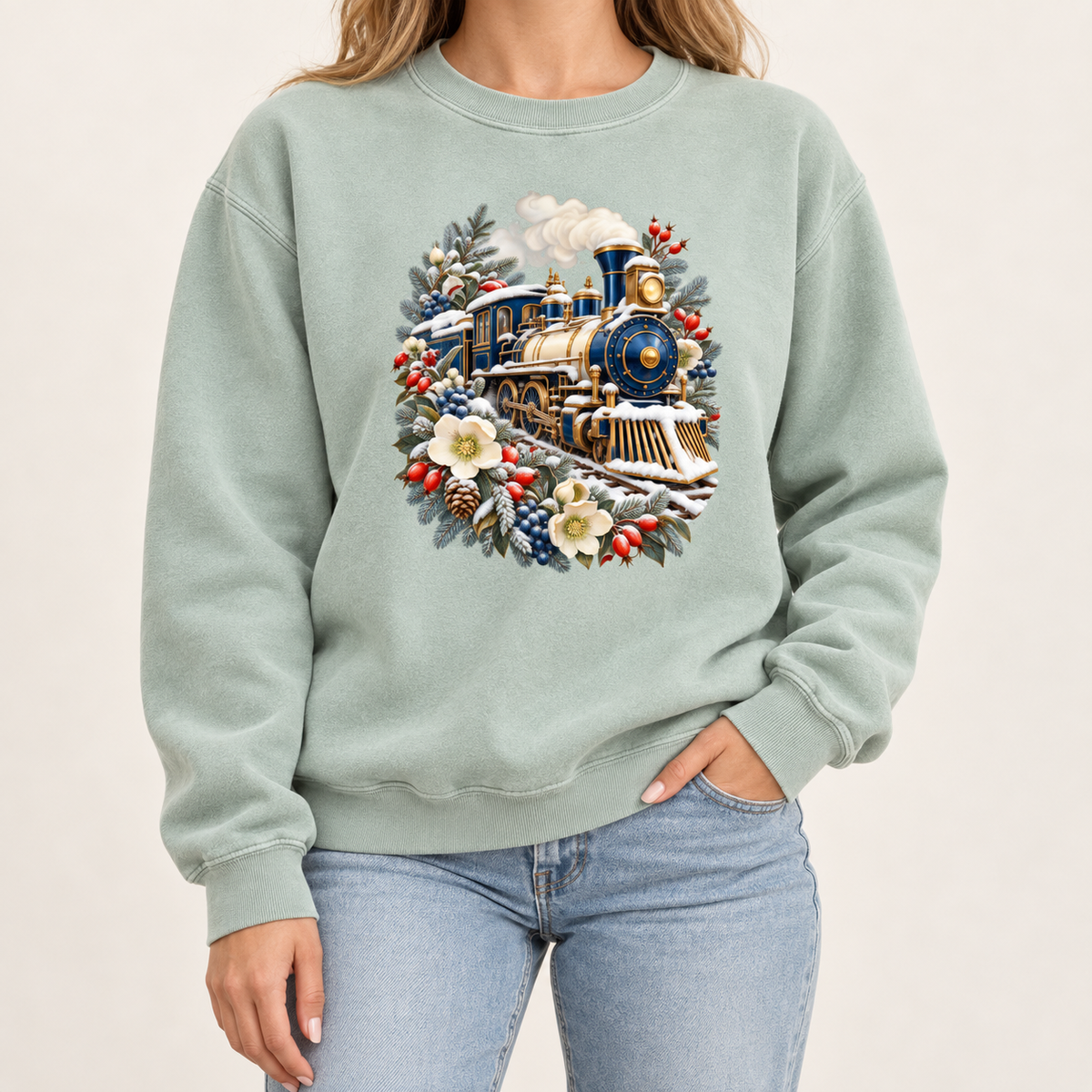 Vintage locomotive design on an 80/20 ring-spun cotton-blend crewneck — a deep blue and gold steam locomotive ringed by snow-dusted evergreen, red berries, pinecones and cream flowers