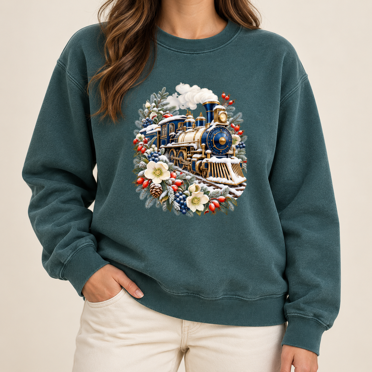Vintage locomotive and botanicals design printed direct-to-garment on garment-dyed fleece — a deep blue and gold steam locomotive ringed by snow-dusted evergreen, red berries, pinecones and cream flowers