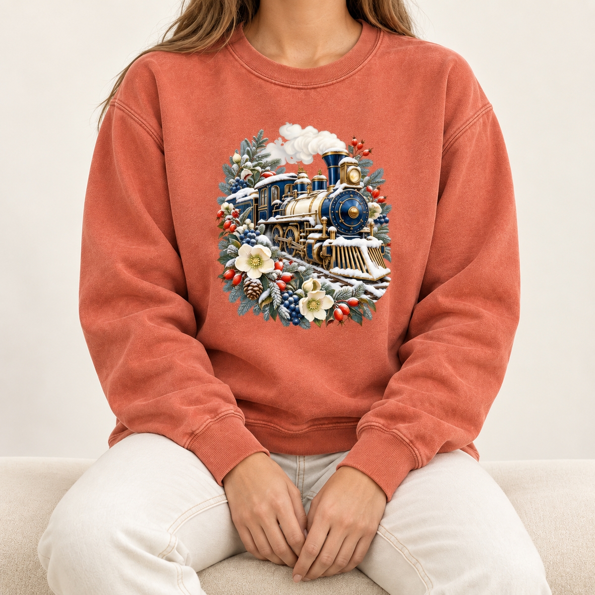 Vintage steam train sweatshirt, large front-centered print, no lettering — a deep blue and gold steam locomotive ringed by snow-dusted evergreen, red berries, pinecones and cream flowers