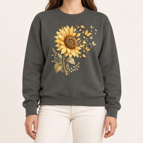 Sunflower butterfly sweatshirt in Pepper – a golden watercolor sunflower letting go of its petals as small gold butterflies, printed large on the chest of a Comfort Colors crewneck
