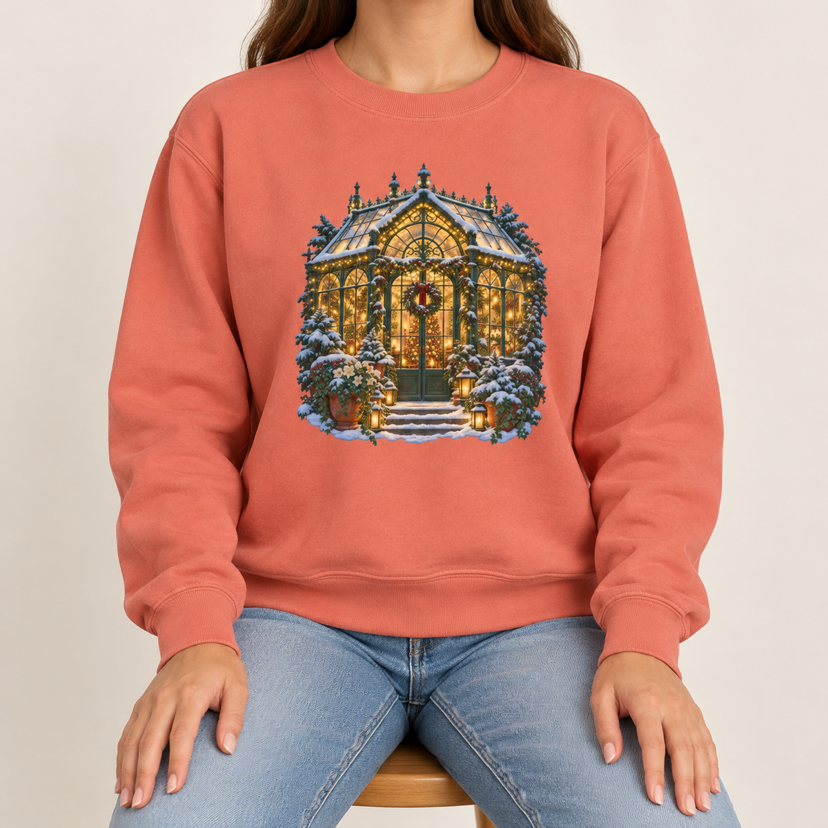 Christmas greenhouse sweatshirt in Terracotta: a snowy Victorian conservatory glowing with warm lights on a warm clay garment-dyed Comfort Colors crewneck