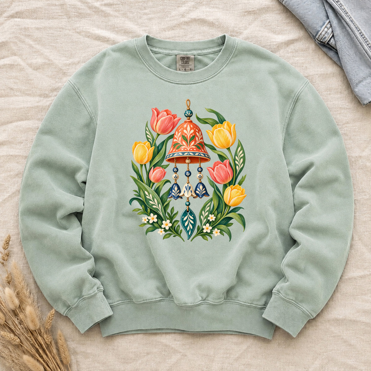 Garden Wind Chime & Tulip Sweatshirt in Chalky Mint — a lively turquoise contrast to the coral and golden flowers