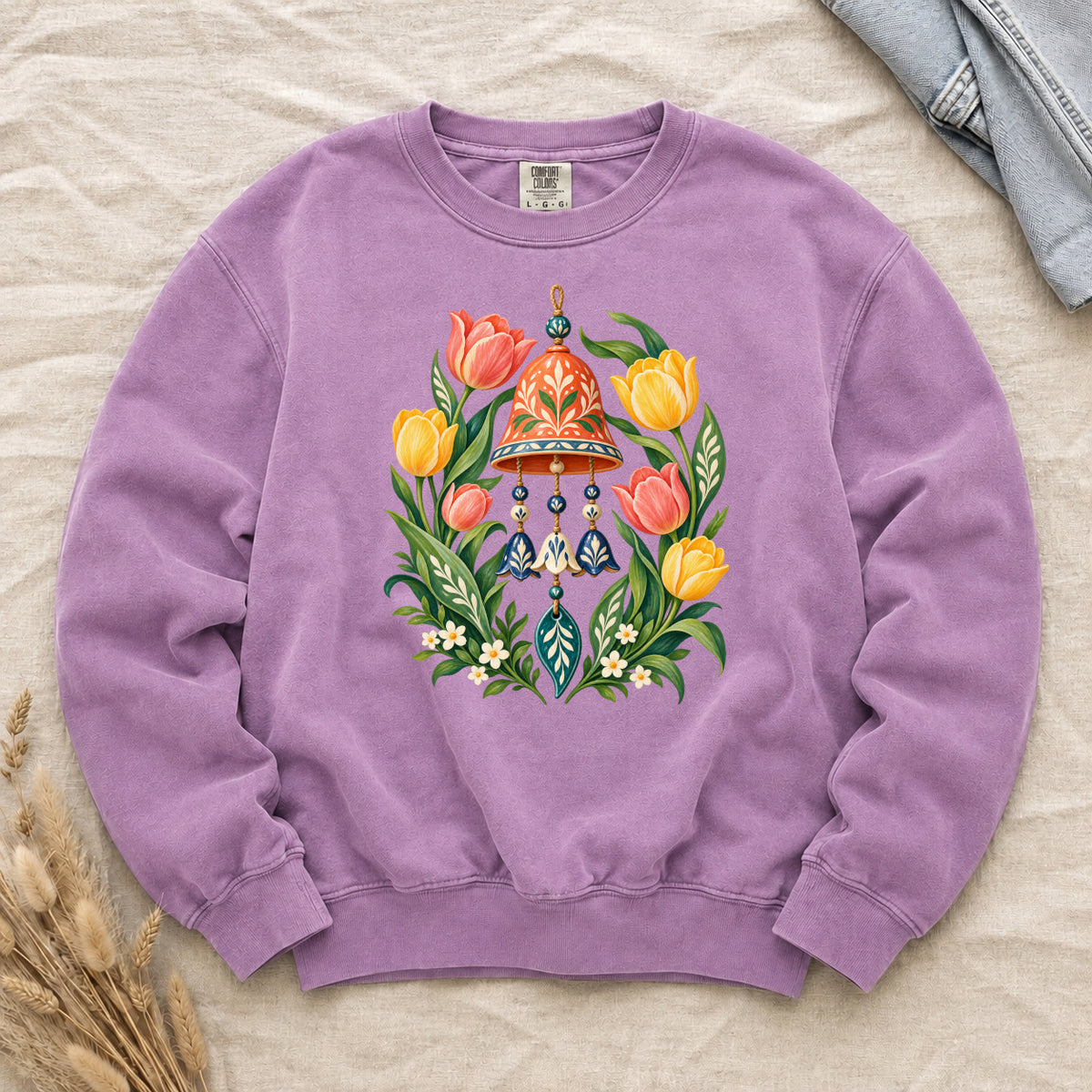 Garden Wind Chime & Tulip Sweatshirt in Orchid — a soft purple backdrop complementing the yellow tulips and green foliage