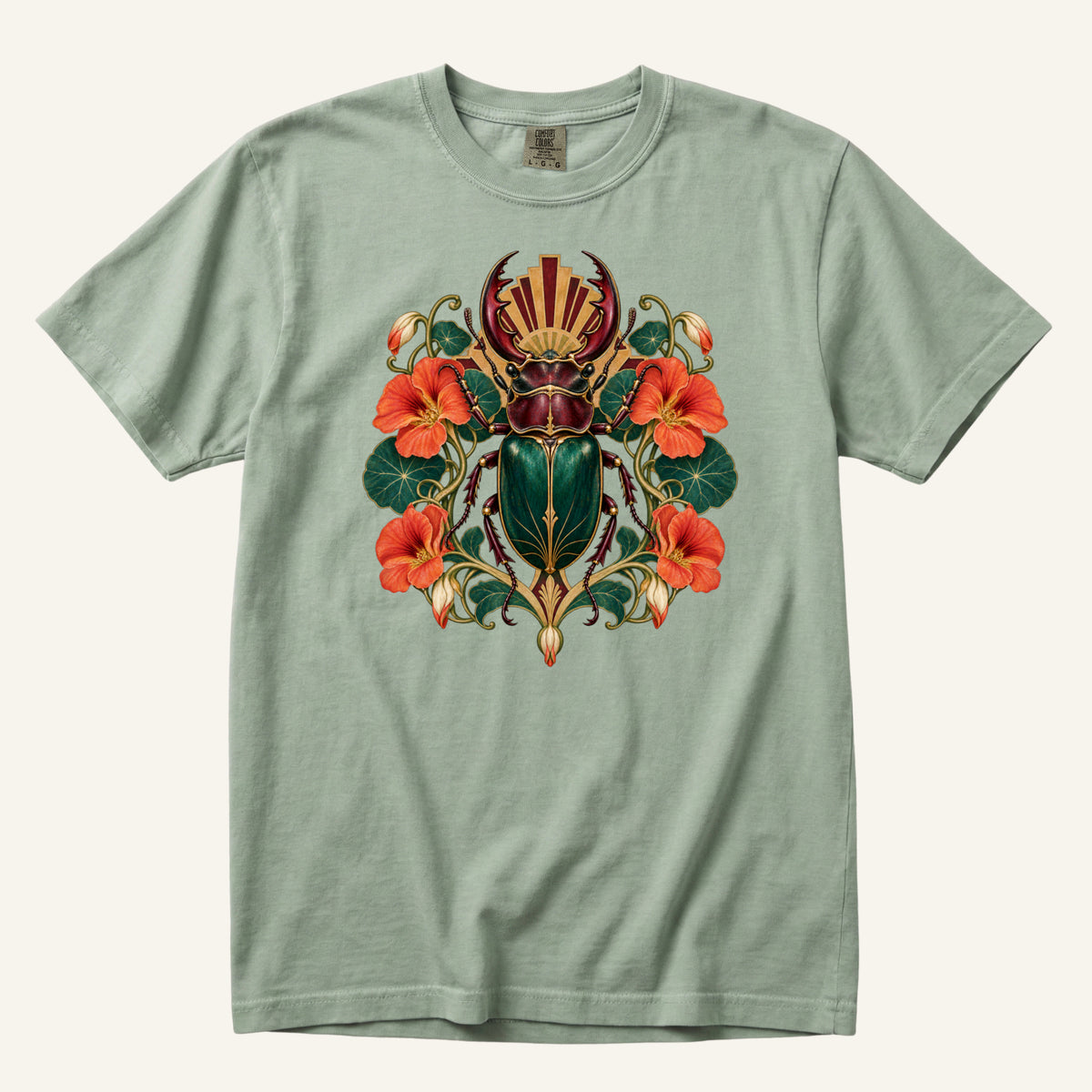 The Emerald Guardian T-Shirt in Bay — soft sage green with the nasturtium and beetle design