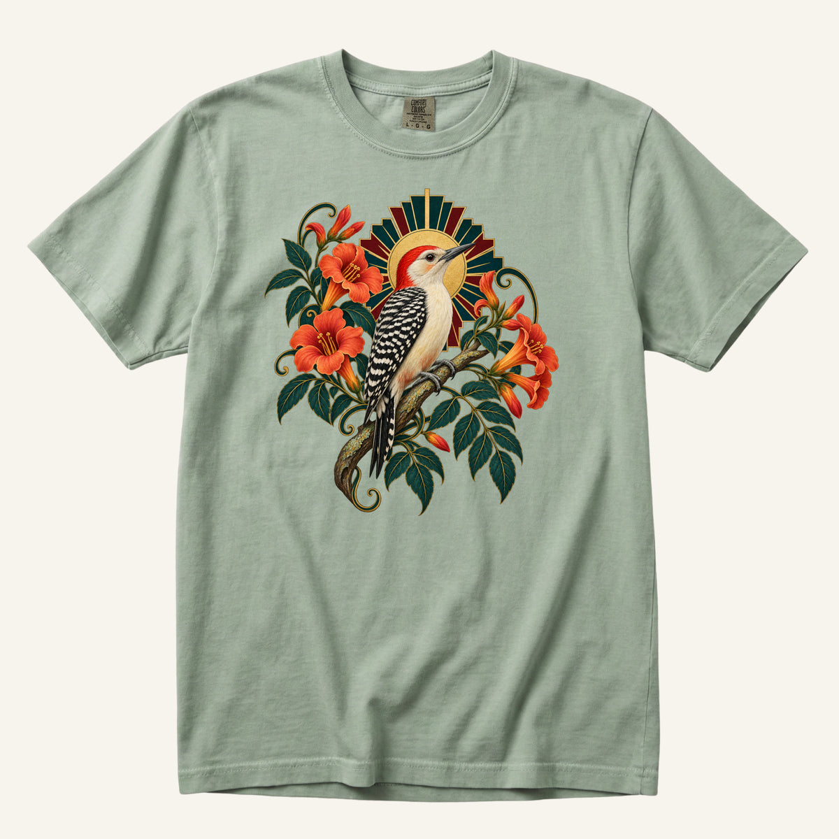 The Morning Drummer T-Shirt in Bay — pale sage that keeps the foliage and bird clear