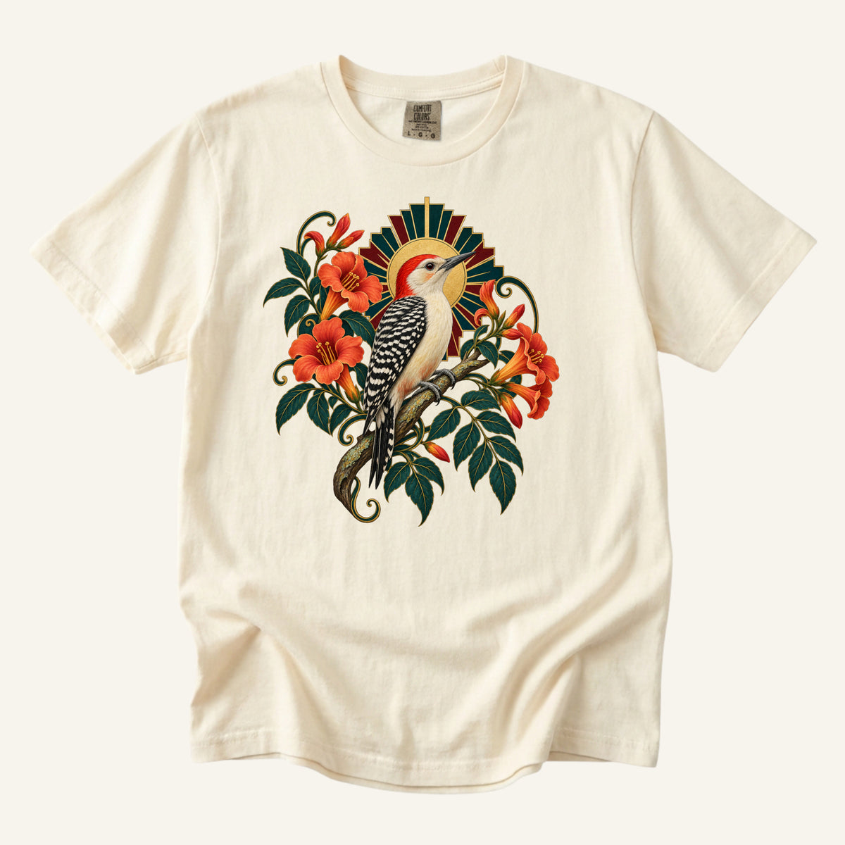 The Morning Drummer T-Shirt in Ivory — a red-crowned woodpecker among orange trumpet flowers with a gold Art Deco sunburst