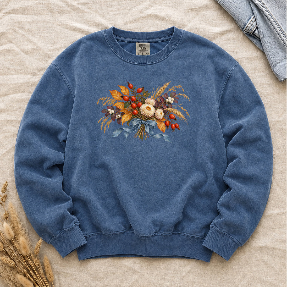 Tied to September sweatshirt in Blue Jean, a tonal autumn bouquet and blue ribbon on faded denim blue