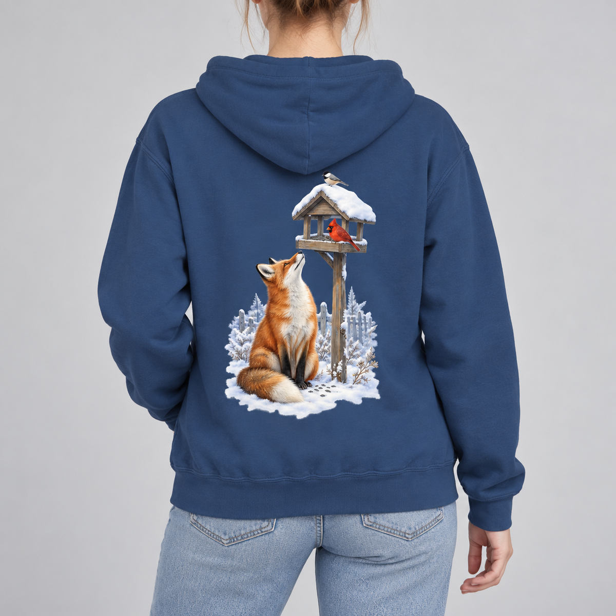 Beneath the Feeder hoodie in True Navy, back view: red fox in the snow looking up at a cardinal on a snow-capped feeder