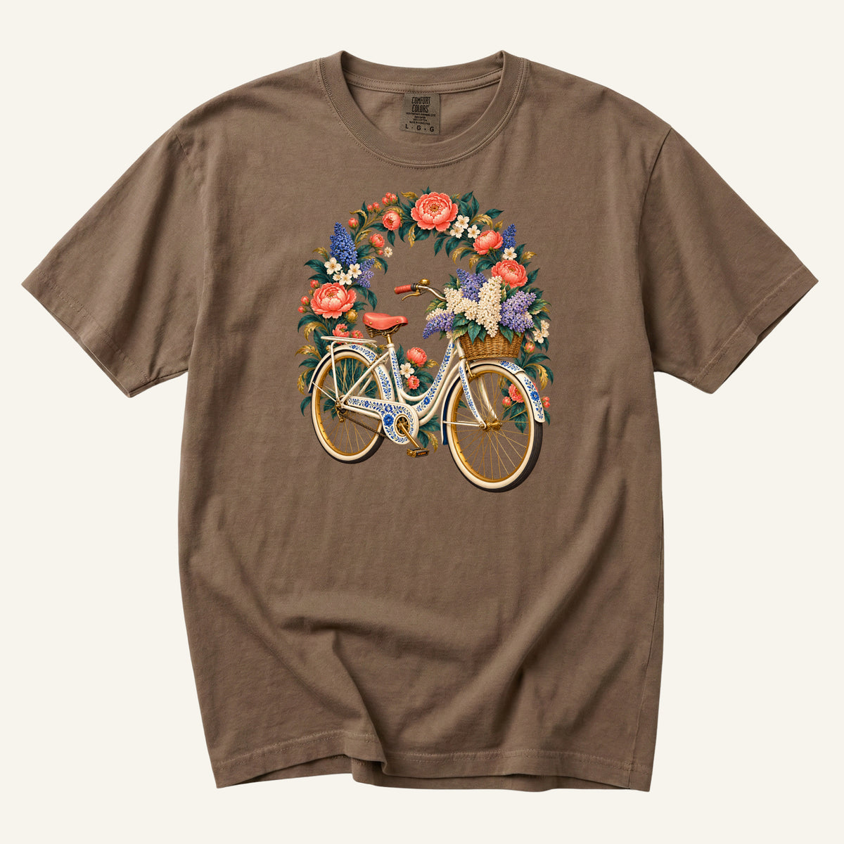 She Took the Flower Route vintage floral bicycle t-shirt in Espresso, a cream-and-gold vintage bicycle beneath an arch of coral roses, its woven front basket overflowing with cream and lavender blooms