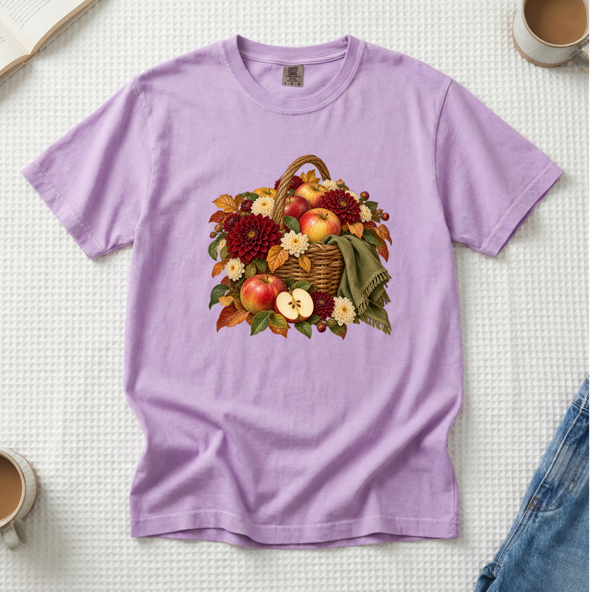 We Picked Too Many tee in Orchid, a basket of apples with autumn flowers and a green scarf