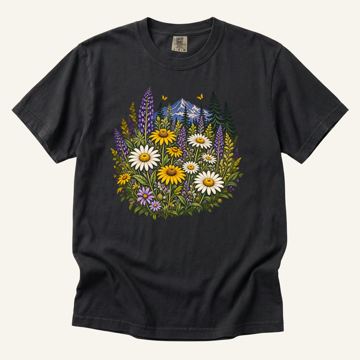 Where the Trail Opens tee in Graphite, white daisies and purple wildflower spikes below evergreens and a snow-touched mountain