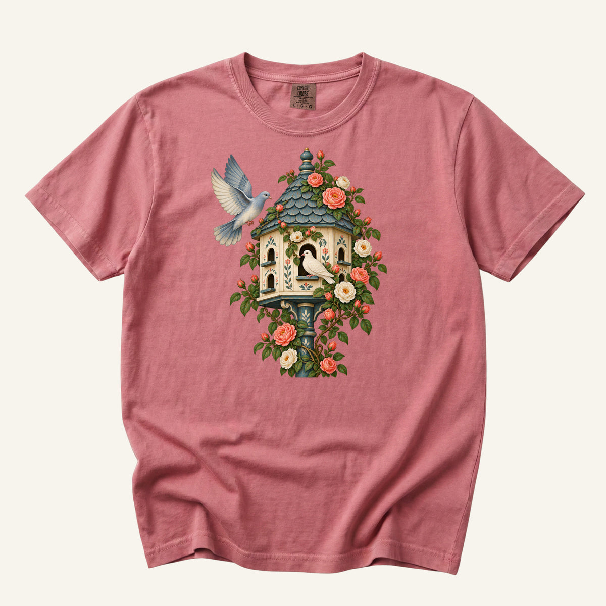 Whoever Gets There First T-Shirt in Crimson — a richer warm setting with the cream dovecote standing out