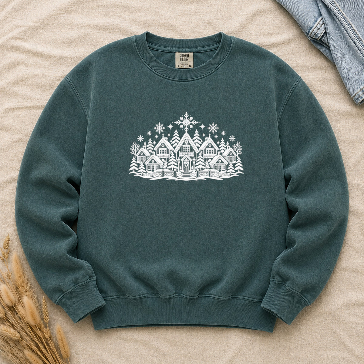 Winter Village White Line Art Sweatshirt in Blue Spruce — the white village and pines on a deep green garment-dyed Comfort Colors crewneck