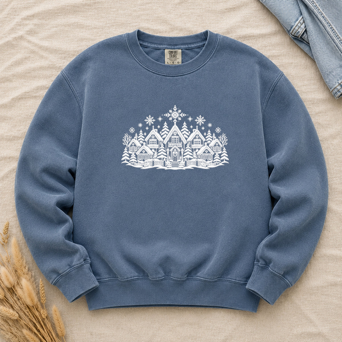Winter Village White Line Art Sweatshirt in Denim — the white village scene on a washed mid-blue garment-dyed crewneck