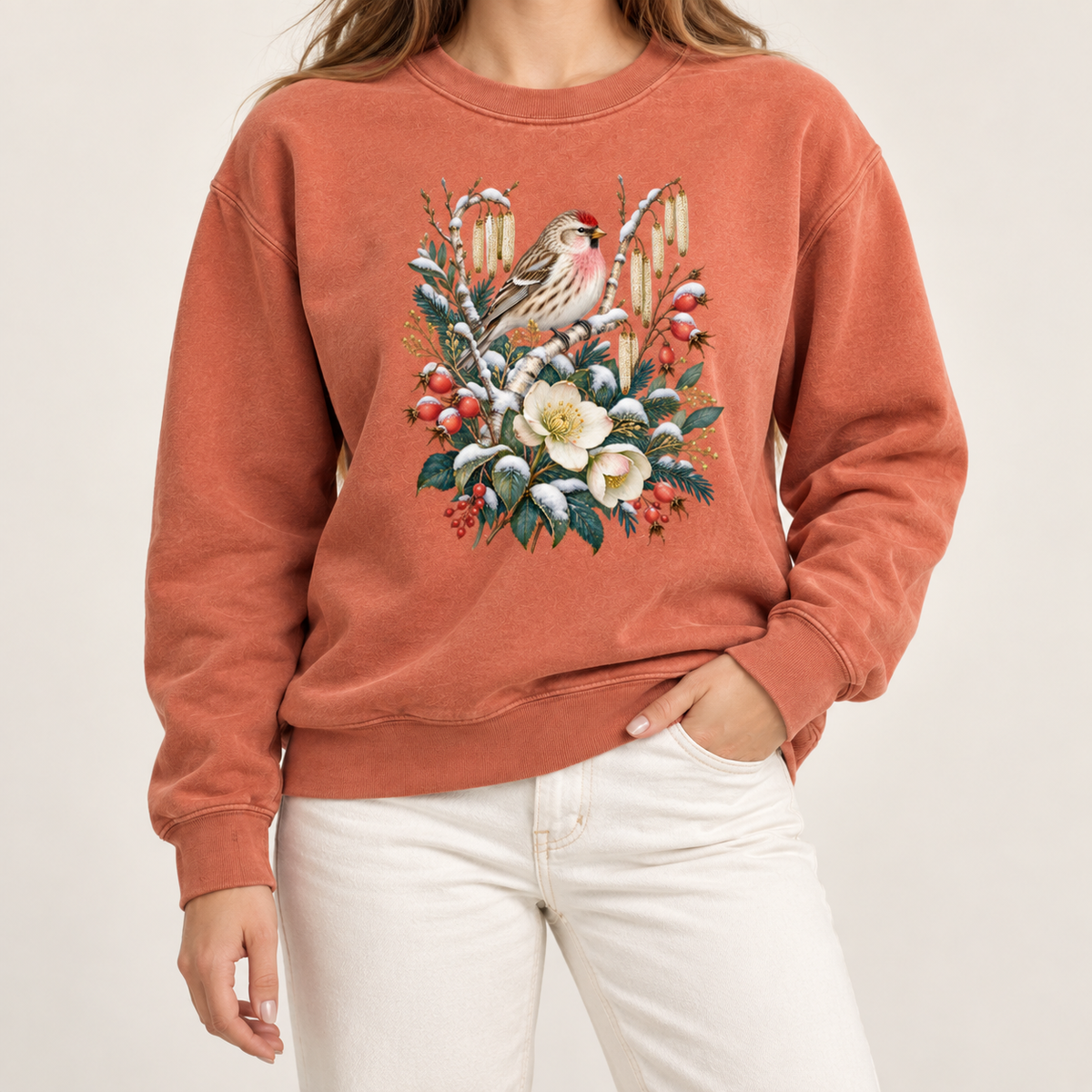 Winter finch and botanical sweatshirt, relaxed unisex fit, adult sizes S to 3XL — a small brown finch with rosy red markings above snow-dusted evergreen, red berries and cream flowers